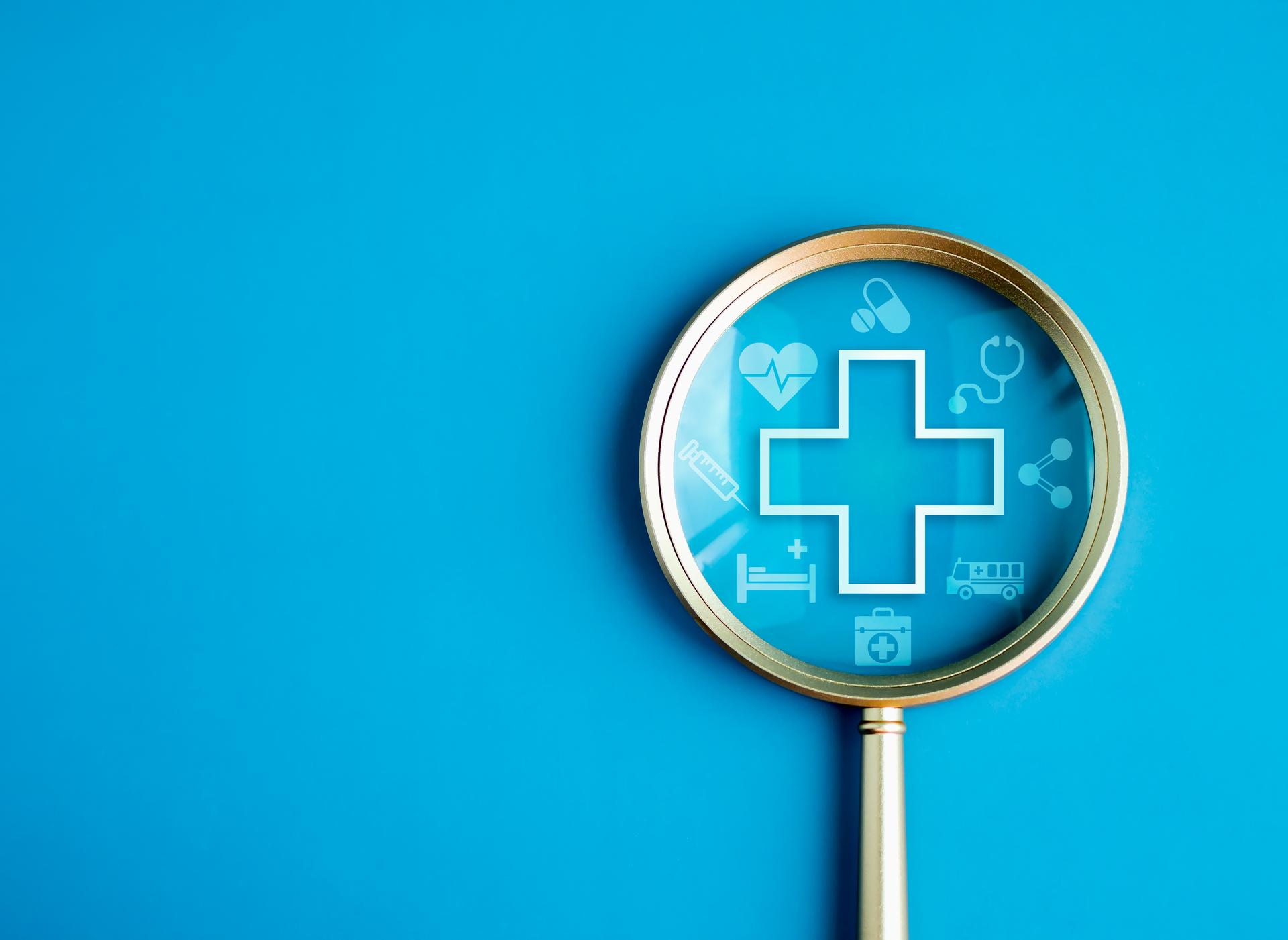 Healthcare service, hospital website online search, wellness plan and insurance concept. Health, care and medical element icon symbols in magnifying glass lens on blue background with copy space.